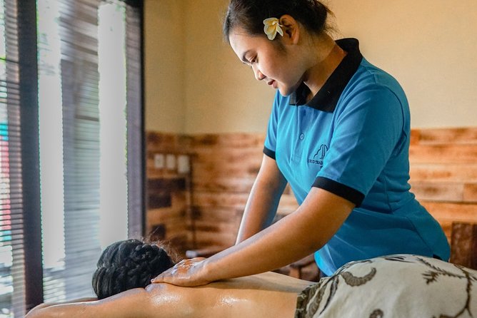 A therapist working a full body oil massage in a spa in Ubud, Bali